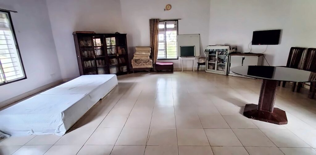 The meditation room at Anand Vihar, a large bright hall with mattresses for sitting