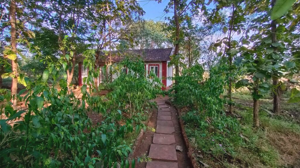 A red-trimmed cottage at the end of a stone path