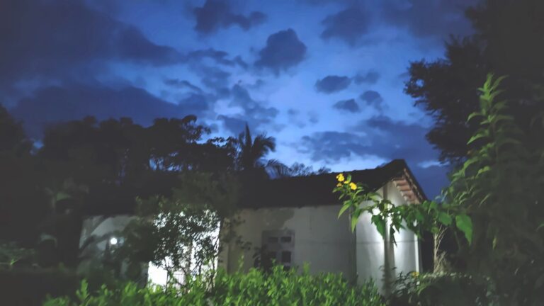 A cottage at dusk under a deep blue sky
