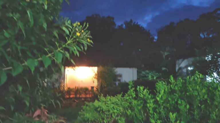 Warm light from a cottage window at dusk